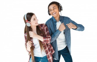 Multiethnic teenagers listening music in headphones