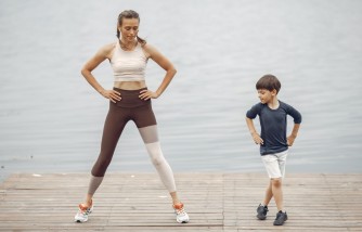 Mother and Son Working Out Together by Lake Shore