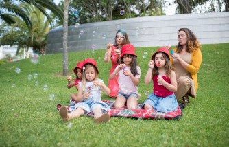 Women and Girls Playing with Bubbles at a Park