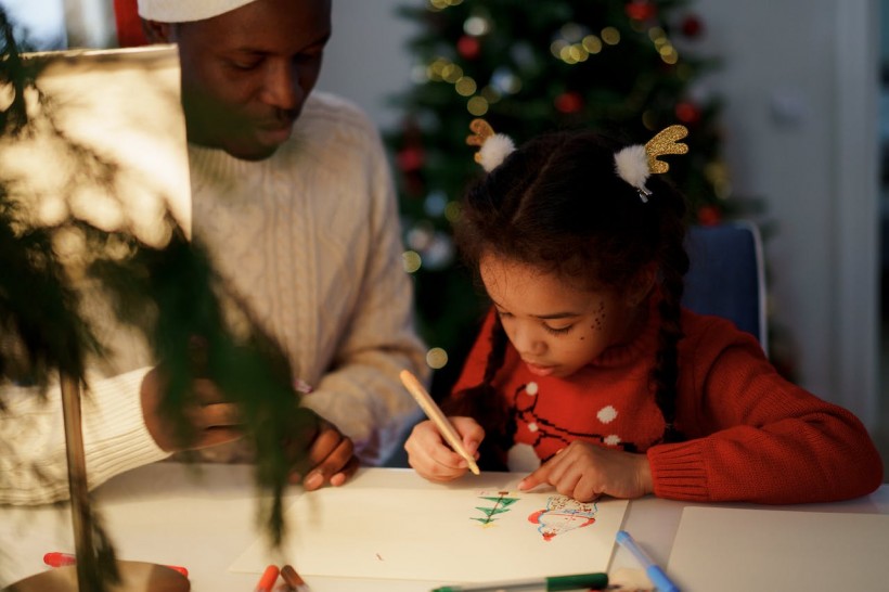 Dad Watching Her Daughter Draw a Christmas Tree
