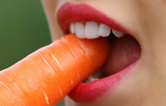 girl biting a carrot