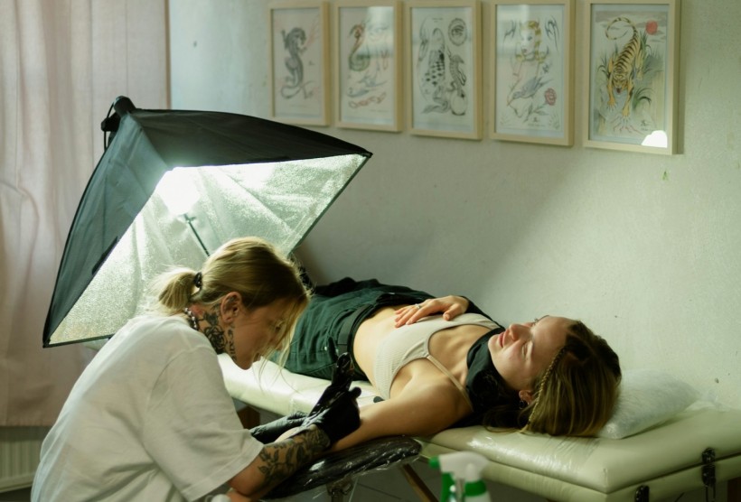 woman during tattoo session