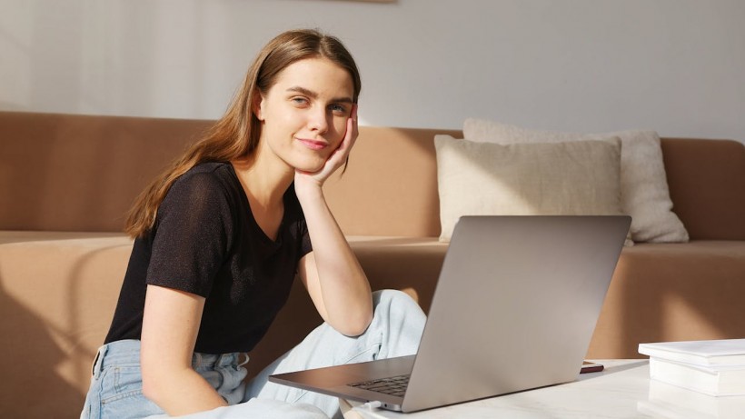 girl in black shirt in front of laptop