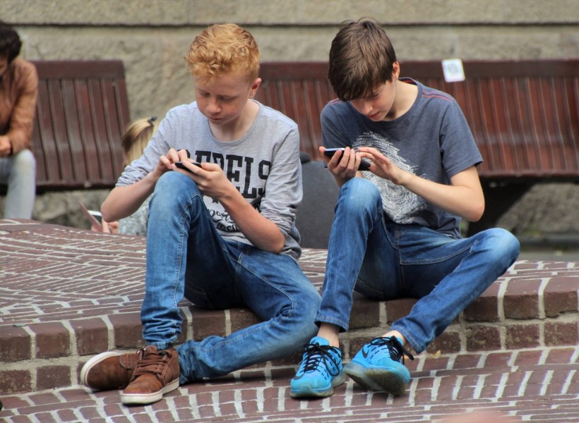 Children playing on their phones